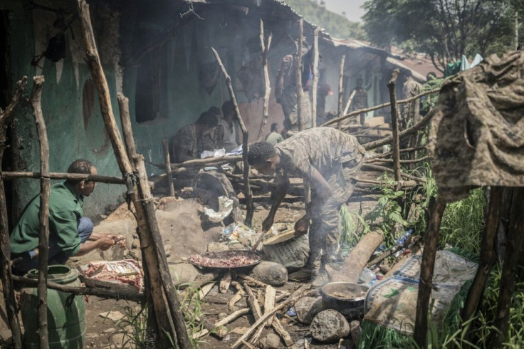 Ethiopian National Defence Force (ENDF) soldiers prepare food in their camp at an undisclosed location in Ethiopia, on September 16, 2021.