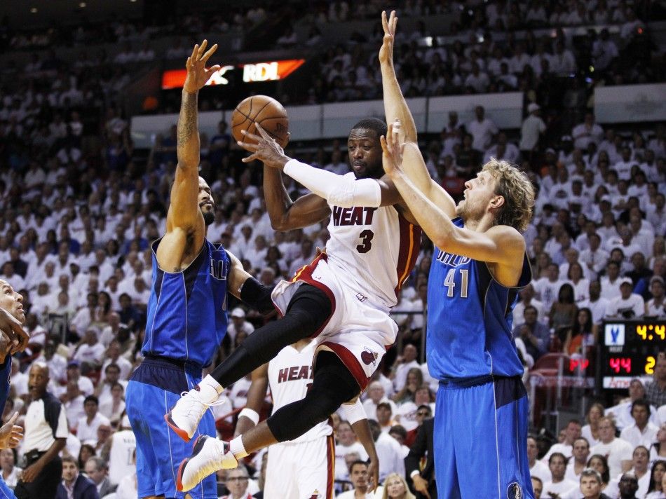 Heat039s Wade drives between Mavericks039 Chandler and Nowitzki during Game 6 of the NBA Finals basketball series in Miami
