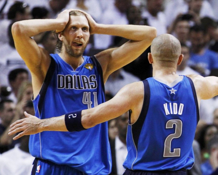 Mavericks&#039; Nowitzki celebrates with teammate Kidd near the end of Game 6 of the NBA Finals basketball series against the Heat in Miami