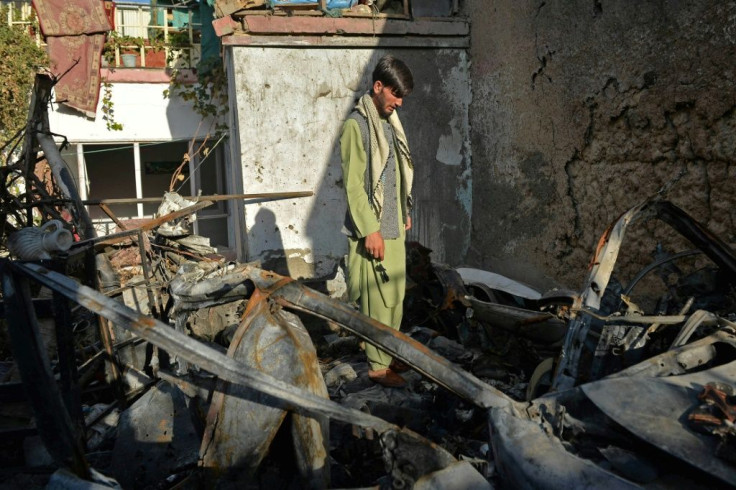 A neighbour of Ezmarai Ahmadi stands amid the debris of Ahmadi's house, damaged in the US drone strike in the Kwaja Burga neighbourhood of Kabul