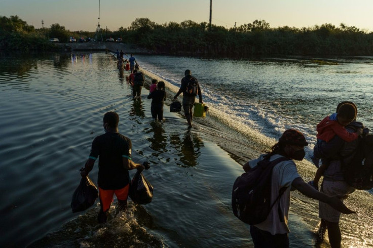 Haitian migrants cross the Rio Grande near the Del Rio-AcunÌa Port of Entry in Ciudad AcuÃ±a, Mexico