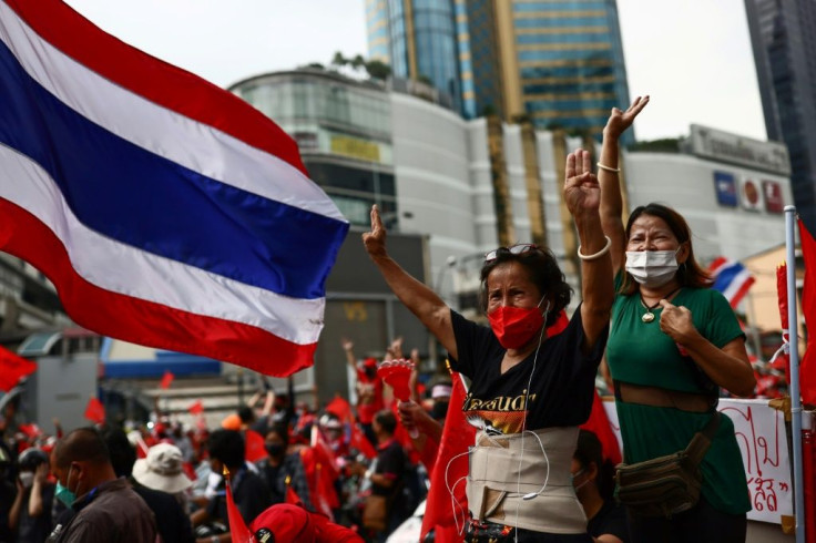 Hundreds of protesters drove through Bangkok's streets to mark the 15th anniversary of a military coup that ousted former premier Thaksin Shinawatra