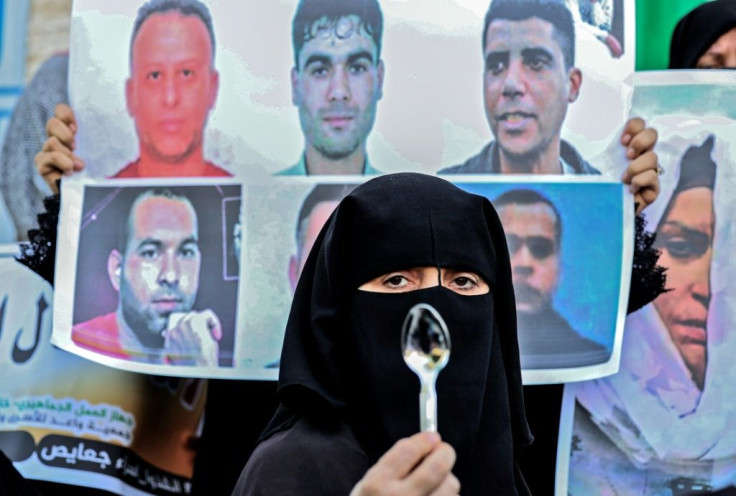 A demonstrator holds up a spoon, a makeshift tool used by six Palestinian militants who escaped from Israel's Gilboa prison, during a solidarity rally on September 8. They have all been recaptured since