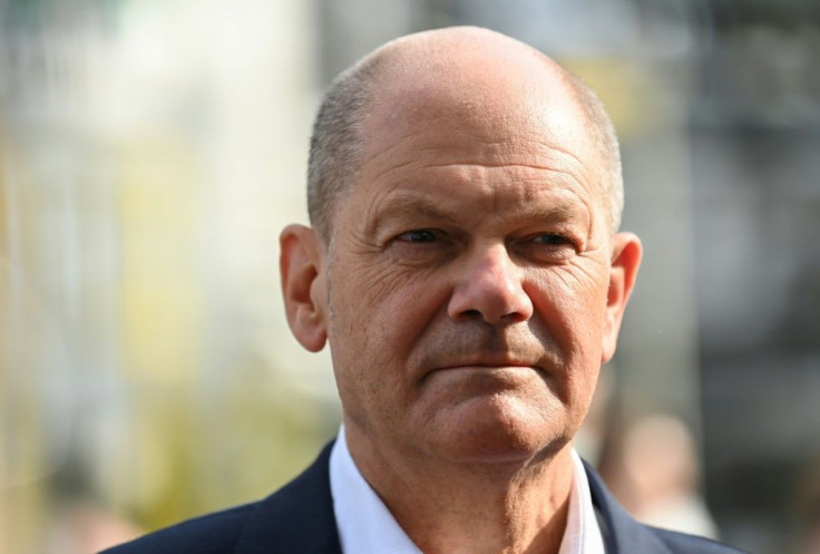 Olaf Scholz has been accused by Angela Merkel's conservatives of brushing the controversy under the carpet