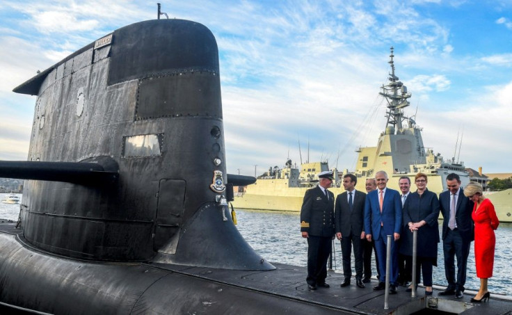French President Emmanuel Macron tours the deck of a submarine with Australia's then prime minister Malcolm Turnbull in Sydney in May 2018