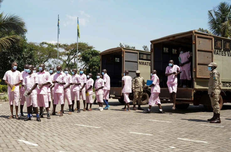 Prison warders guard the defendants in the case