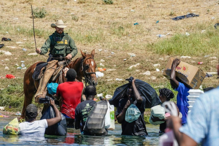 A United States Border Patrol agent on horseback uses his reins as he tries to stop Haitian migrants from entering an encampment on the banks of the Rio Grande near the Acuna Del Rio International Bridge in Del Rio, Texas