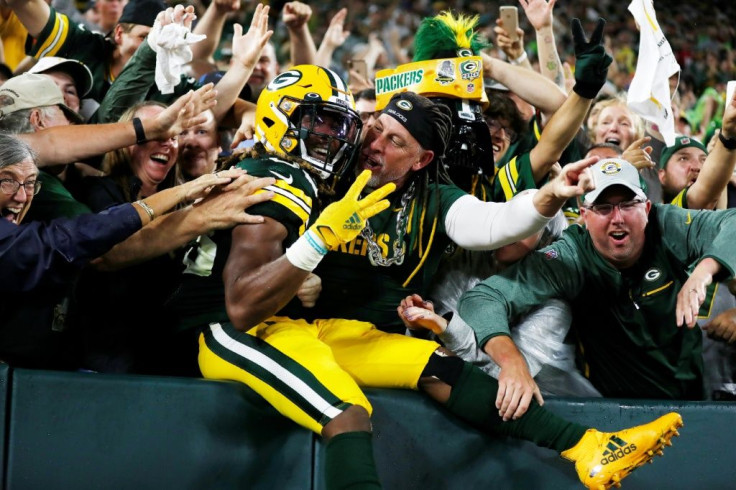 Jones celebrates his third touchdown of the night against the Detroit Lions with Green Bay fans during the second half at Lambeau Field