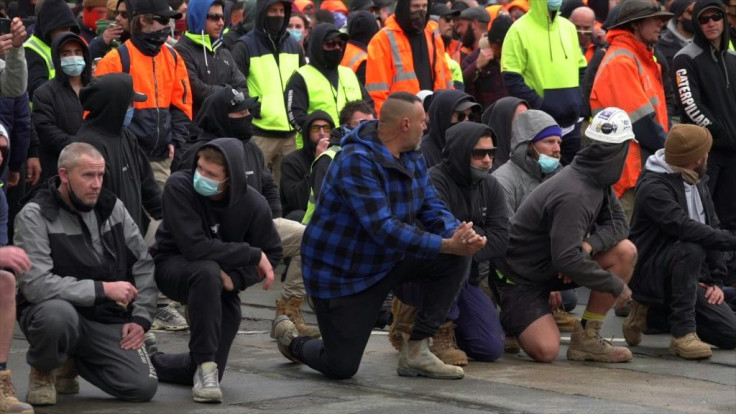 Protesters march in Melbourne opposing new vaccine mandates for construction workers and Covid-19 lockdowns.