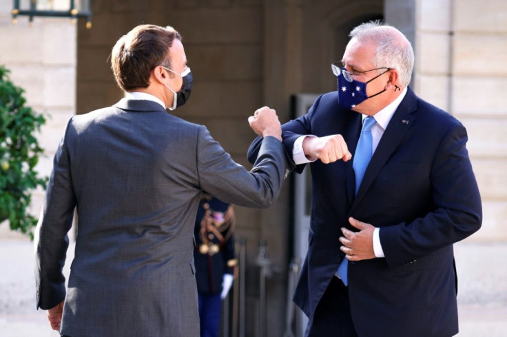 French President Emmanuel Macron greets Australia's Prime Minister Scott Morrison at the Elysee Palace in Paris on June 15, 2021