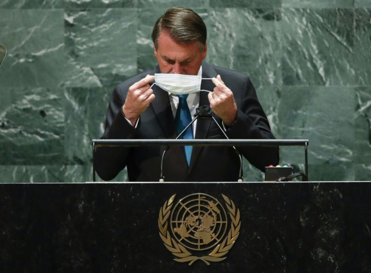 Brazil's President Jair Bolsonaro puts back on a protective facemask after he addresses the UN General Assembly