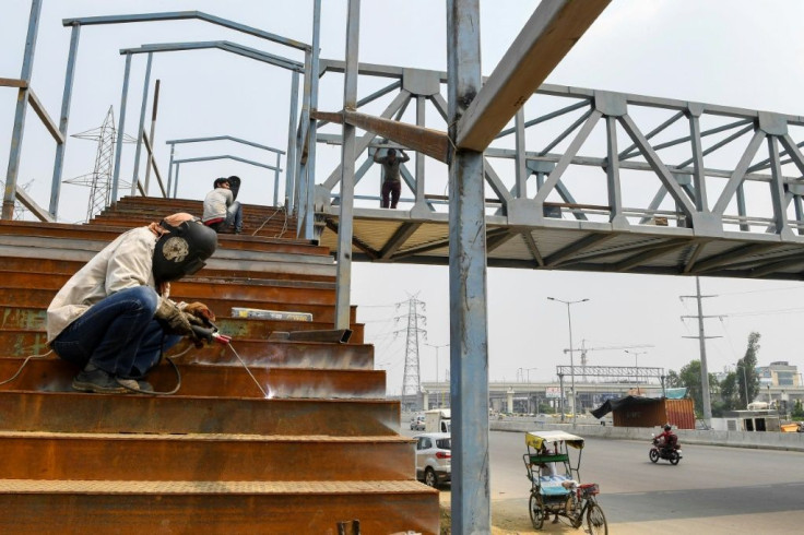 Workers build a bridge in Ghaziabad, India. The Asian Development Bank has cut its growth forecast for developing Asia