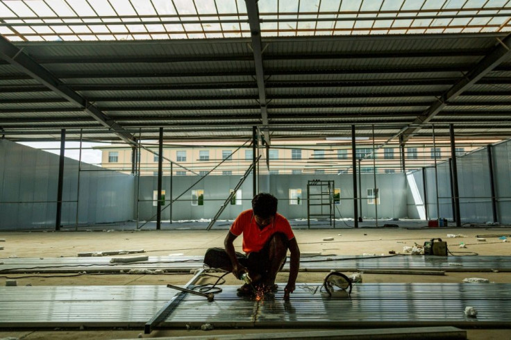 A labourer works to construct a new Covid-19 coronavirus quarantine centre in 115 Mile in Muse, near the China-Myanmar border