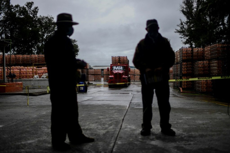Members of Mexico's indigenous communities guard a bottling plant they have occupied in the central state of Puebla