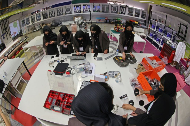 Members of an all-girl Afghan robotics team assemble components for a circuit board they are building, at the laboratory of Qatar's Texas A&M university in the capital Doha