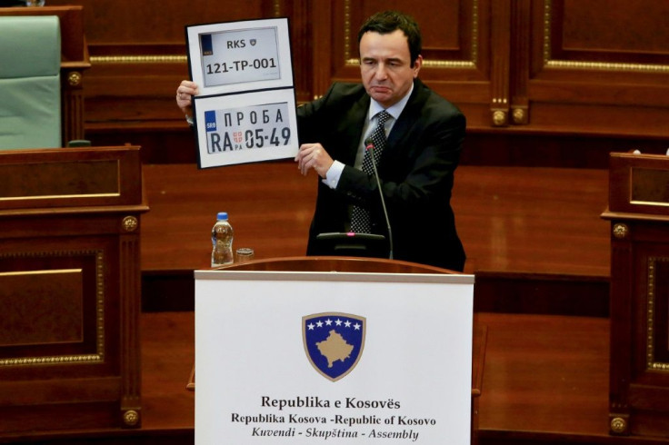 Kosovo Prime Minister Albin Kurti shows Kosovo and Serbia temporary car plates during a parliament session in Pristina on September 20, 2021