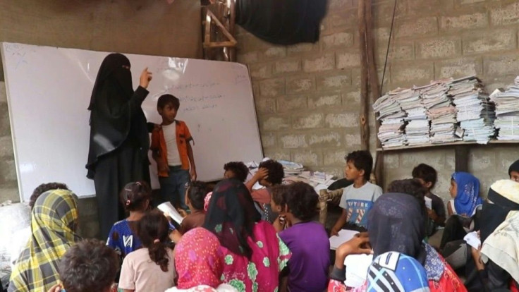 In a remote village in the southern Yemeni province of Hodeida, teacher Amina Mahdi gives a science lesson to children sprawled across the ground at her home, providing their only opportunity for an education in the rural area