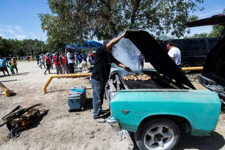 A man cooks chicken for Haitian migrants in Ciudad Acuna in northern Mexico