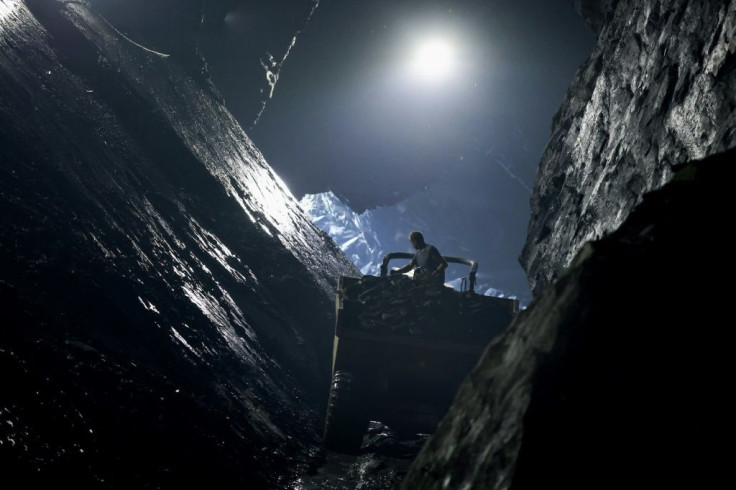 Theret works alone in a vast cathedral-like underground chamber