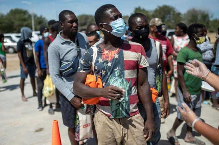 Haitian migrants queue to get food at a shelter in Ciudad Acuna, Mexico, across the border from Del Rio, Texas, where many have traveled hoping to remain in the United States.