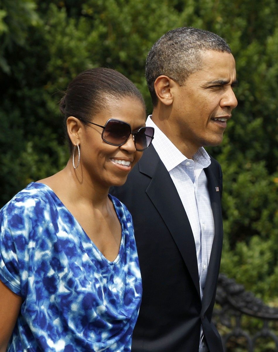 U.S. President Obama walks with his wife towards Marine One before departing for Camp David in Maryland