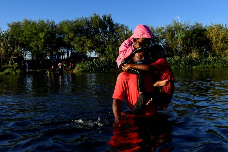 Haitian migrants cross the Rio Grande river that separates Mexico and the United States