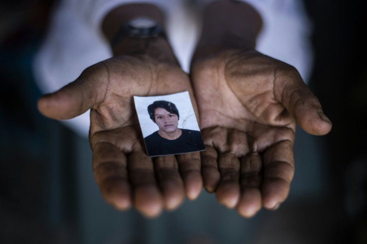Angelica Lapa with a photo of her son Luis Fernando, killed in the attack on May 23