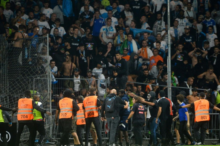 Fans in the Marseille end invade the pitch during their team's 0-0 draw with Angers in Ligue 1 on Wednesday