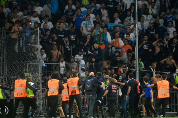 Fans in the Marseille end invade the pitch during their team's 0-0 draw with Angers in Ligue 1 on Wednesday