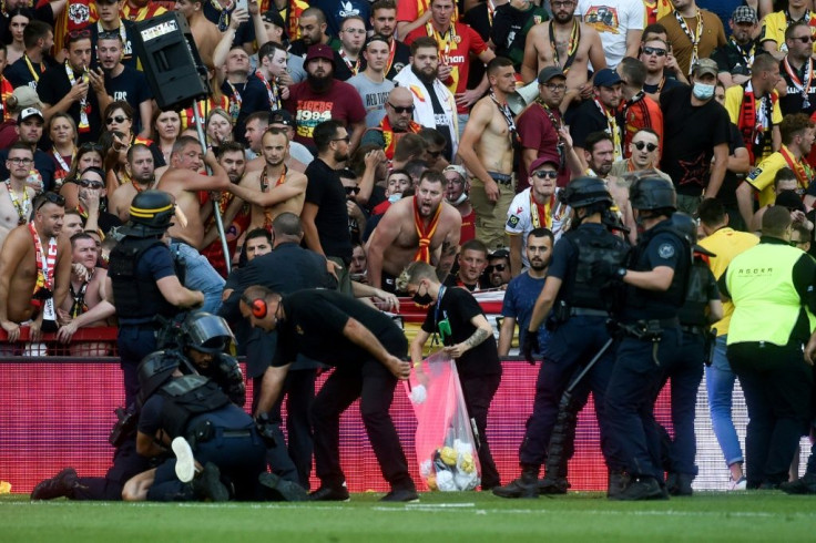 Riot police arrest a man during the trouble in the northern derby between Lens and Lille