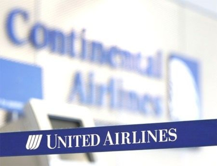 A Continental Airlines logo looms over a United Airlines logo in Chicago's O'Hare International Airport May 3, 2010