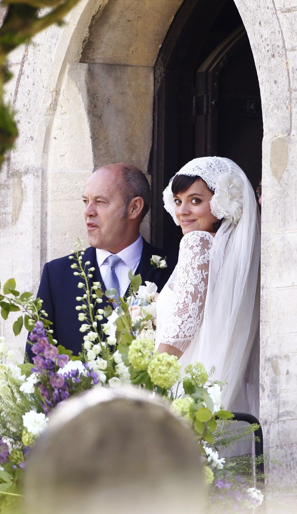 British Singer Lily Allen waits with her father Keith to walk down the aisle during her wedding to Sam Cooper at St James the Great Church in Cranham, Gloucestershire, western England, June 11, 2011