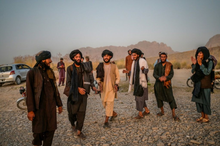 Young members of the Taliban dance and sing next to a river near Kandahar