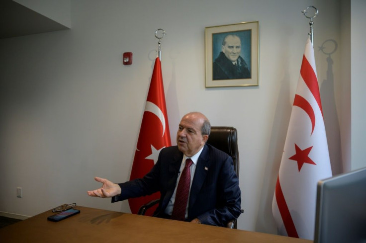 Turkish Cypriot leader Ersin Tatar sits beneath a portrait of the founder of modern Turkey, Kemal Ataturk, as he speaks with AFP in his office at the Turkish Center near the United Nations