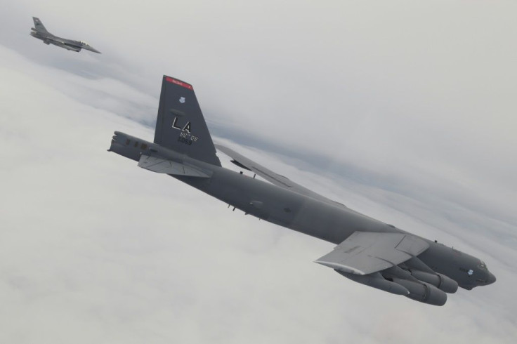 A US bomber B-52 bomber (R) accompanied by an Indonesian F-16 fighter jet (L) during a joint exercise over Sulawesi waters in Indonesia.