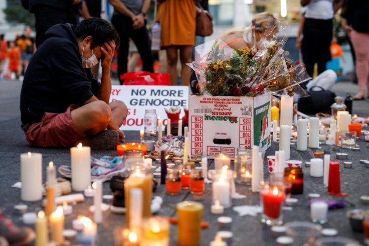 A man holds his head as he attends an impromptu vigil at an anti-Canada Day event titled "No Pride in Genocide" in Toronto in July 2021