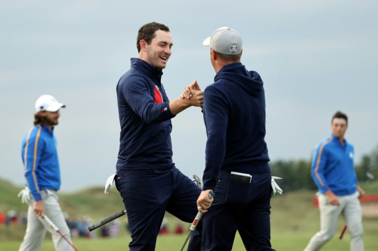 Americans Justin Thomas and Patrick Cantlay celebrate as they rally to tie Europe's Tommy Fleetwood and Viktor Hovland in a Ryder Cup four-balls at Whistling Straits