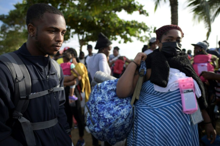 Haitian migrants Benedictine Point Du Jour (R) and her son Roberth are undeterred in their quest to make it to the United States, come what may