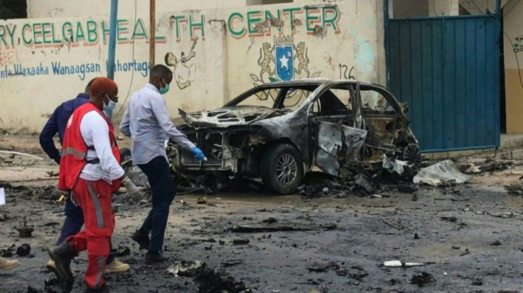 IMAGESPolice and emergency officials work near the wreck where a car bomb killed eight people near Somalia's presidential palace in Mogadishu on Saturday. Al-Shabaab jihadist group claimed responsibility for the attack.