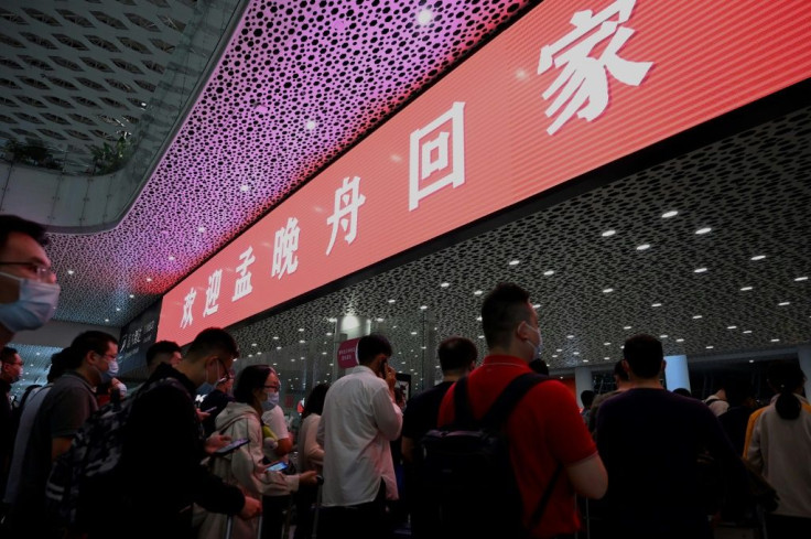 A red banner hanging at Shenzhen airport arrivals hall read "Welcome home Meng Wanzhou" and a crowd of about 200 supporters gathered waving Chinese flags and banners