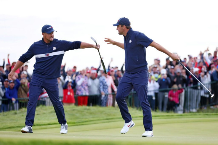 Bryson DeChambeau, left, and United States teammate Scottie Scheffler celebrate on Saturday as the Americans seized an 11-5 lead entering Sunday's final singles matches of the 43rd Ryder Cup