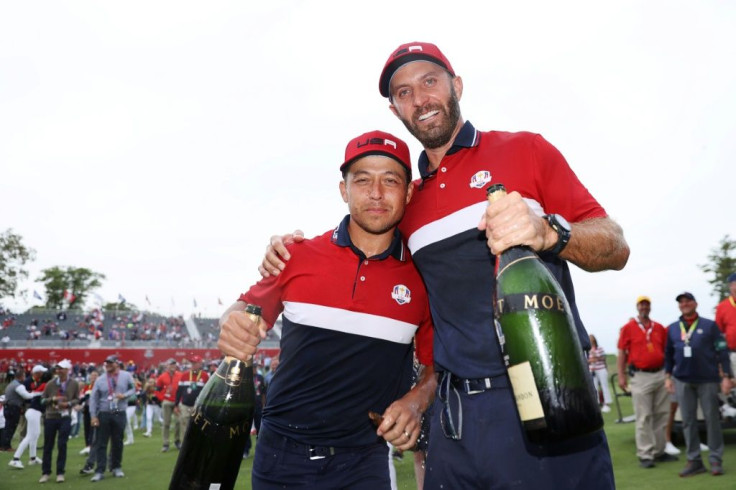 Winners: Dustin Johnson and Xander Schauffele celebrate the United States' 19-9 rout of Europe in the 143rd Ryder Cup