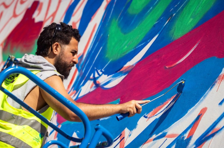 Moroccan street artist Omar Lhamzi works on a mural during the "Jidar" street art festival in the capital Rabat