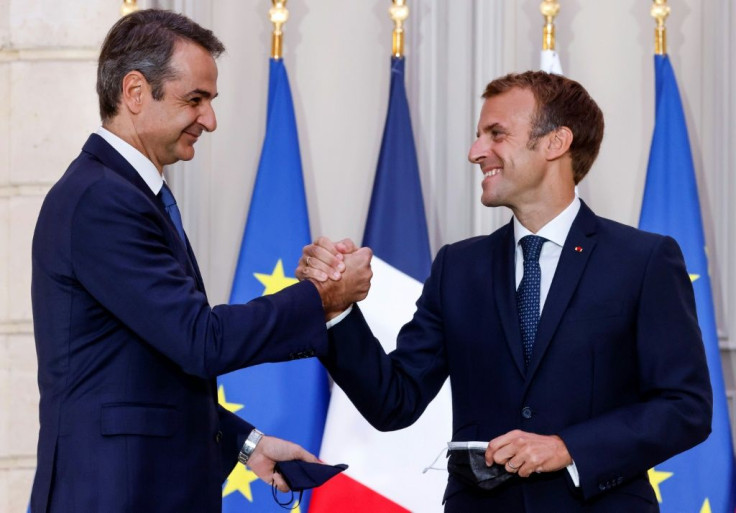 Macron (R) signed the ship deal with Greek Prime Minister Kyriakos Mitsotakis at the Elysee Palace in Paris