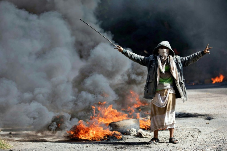 A Yemeni man next to burning tyres during protests calling for the removal of the Saudi-backed coalition government and deteriorating economic and living conditions, in Yemen's third city of Taez on September 27