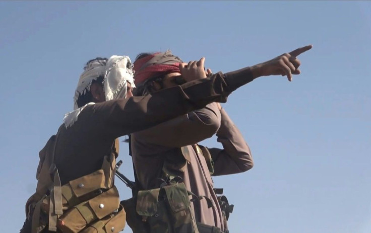 A grab from an AFPTV video shows Yemeni pro-government fighters looking at positions of the Iran-backed Huthi rebels near the loyalists' last northern bastion, the strategic city of Marib, on September 27