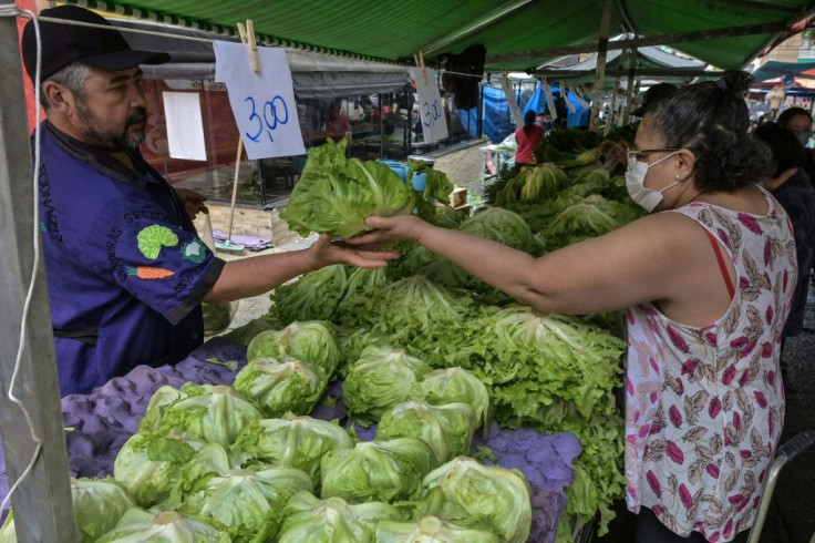 A woman shops at Feira Livre market in Sao Paulo, Brazil -- inflation is running high, especially on food