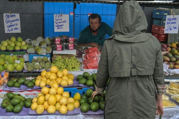 Shoppers like this woman at the Feira Livre market in Sao Paulo, Brazil are coping with rising food prices in the country