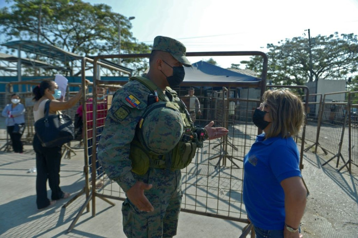 An inmate's relative speaks with a soldier on September 29, 2021 outside the prison in Guayaquil, Ecuador where dozens were killed