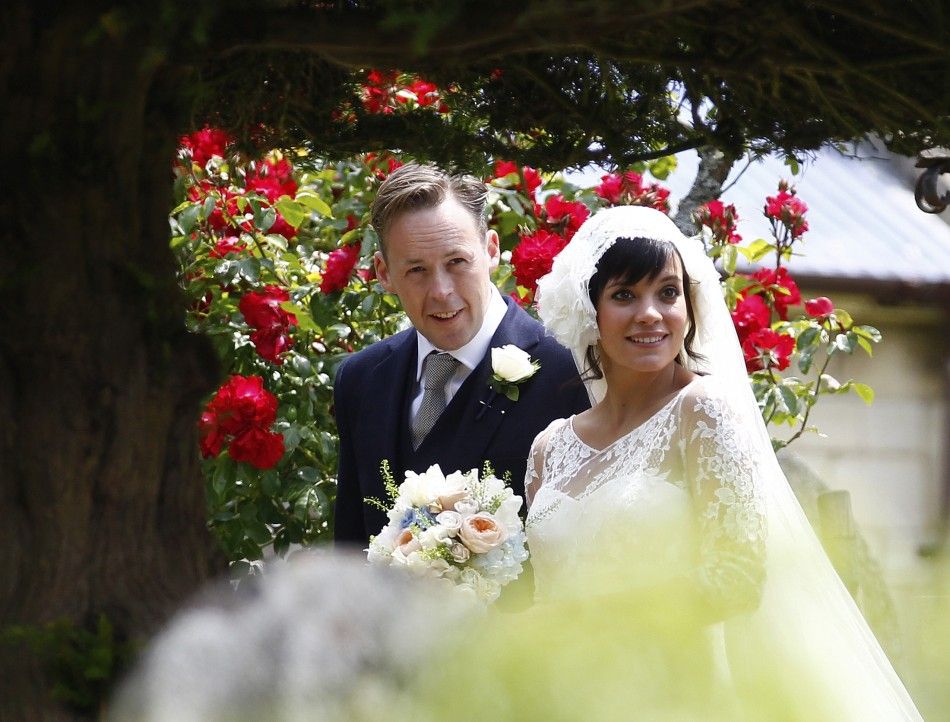 British Singer Lily Allen smiles after marrying Sam Cooper as the couple leaves St James the Great Church in Cranham, Goucestershire, western England, June 11, 2011.